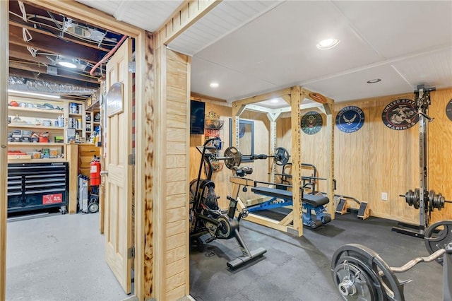 exercise area with a workshop area and wood walls