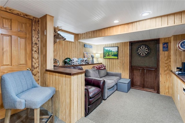 interior space featuring wooden walls and light colored carpet