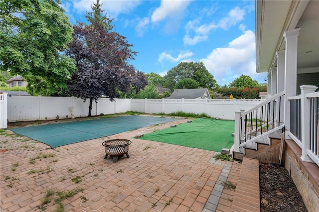 view of pool with a patio and a fire pit