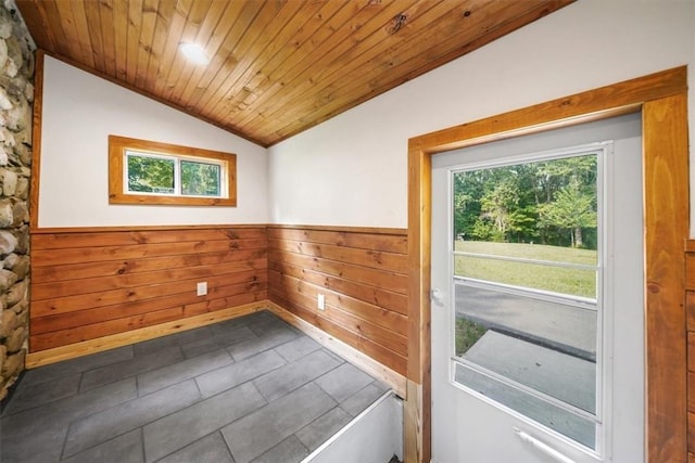 doorway with wood walls, lofted ceiling, and wood ceiling