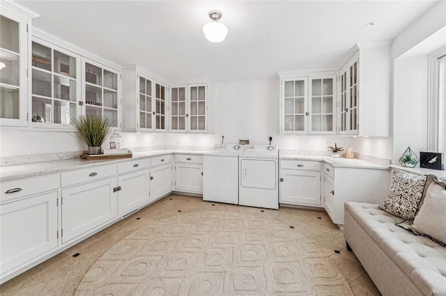 kitchen with white cabinetry and independent washer and dryer