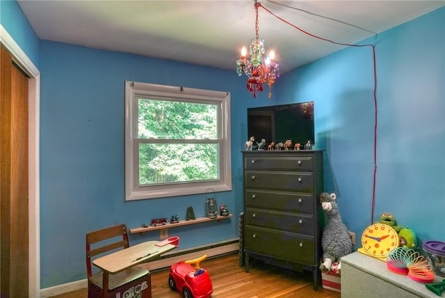 game room featuring a chandelier and hardwood / wood-style flooring