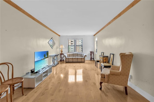 living room featuring crown molding and light hardwood / wood-style floors