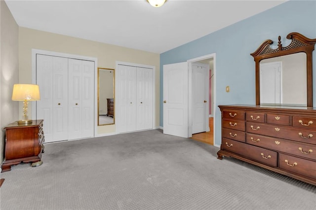 carpeted bedroom with two closets