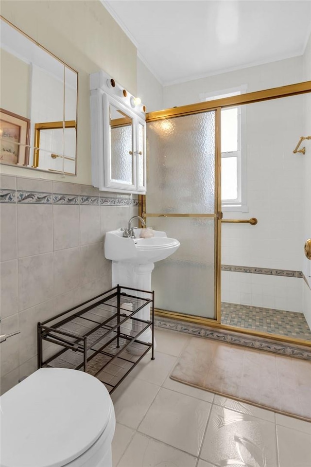 bathroom featuring walk in shower, ornamental molding, tile walls, tile patterned flooring, and toilet