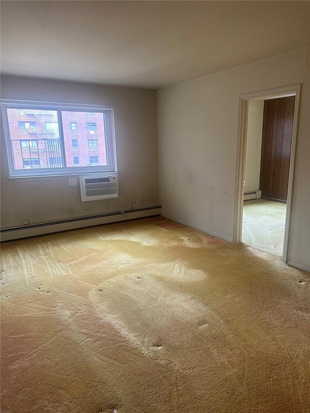 carpeted empty room with an AC wall unit and a baseboard heating unit