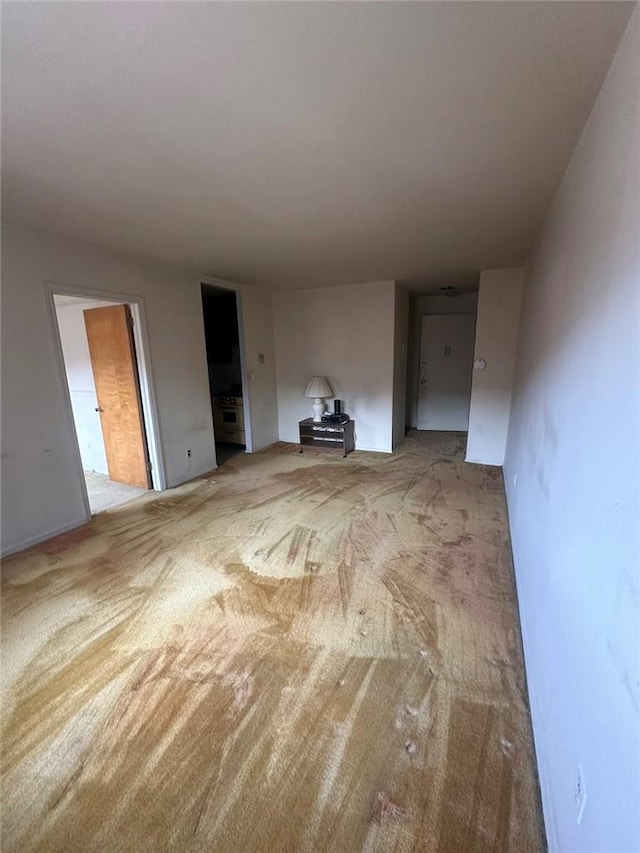 unfurnished living room featuring carpet flooring
