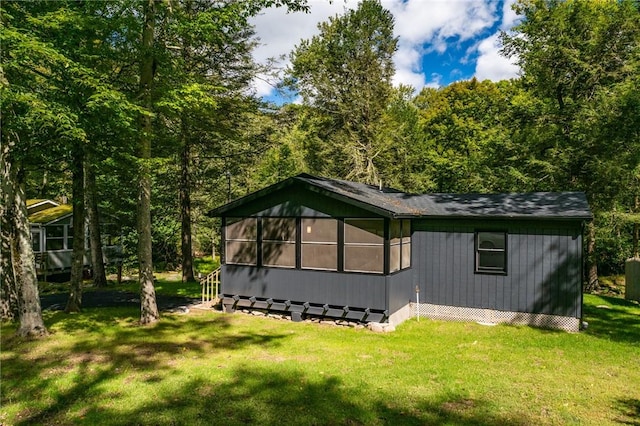 view of side of property with a lawn