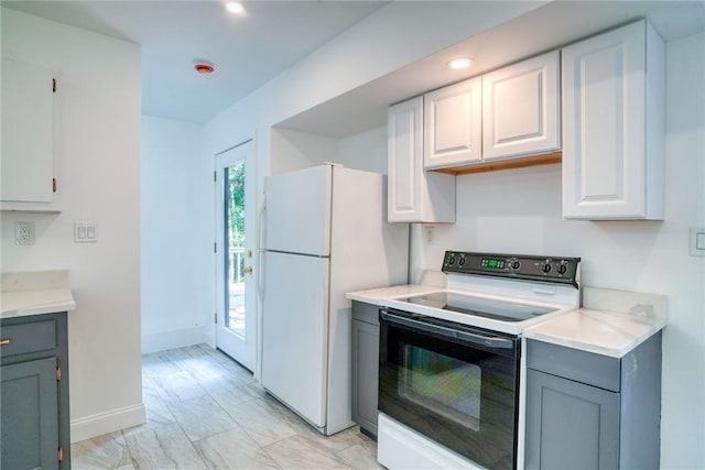 kitchen featuring white appliances, gray cabinets, and white cabinetry