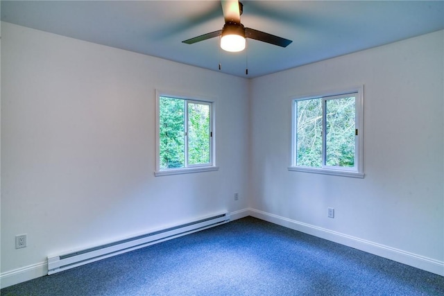 carpeted spare room with a healthy amount of sunlight, ceiling fan, and a baseboard heating unit