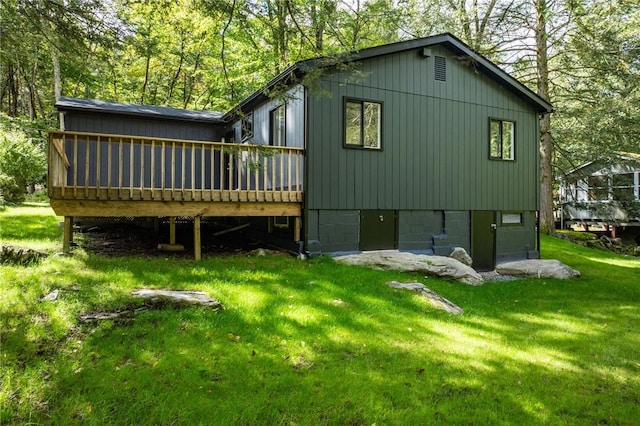 back of house featuring a yard and a deck