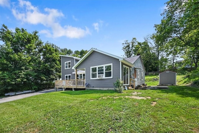 back of house featuring a yard, a shed, and a deck