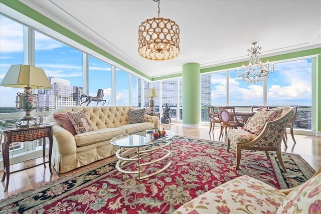 sunroom / solarium featuring an inviting chandelier