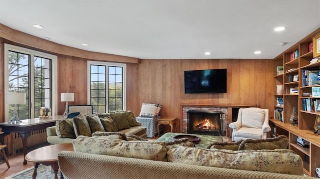 living room with radiator and wood walls