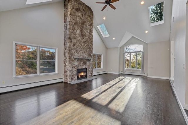 unfurnished living room featuring a stone fireplace, high vaulted ceiling, dark wood-type flooring, and a baseboard heating unit