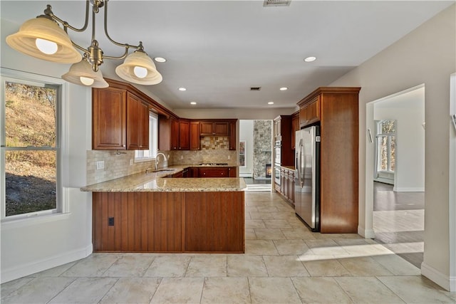 kitchen with a healthy amount of sunlight, sink, appliances with stainless steel finishes, and tasteful backsplash