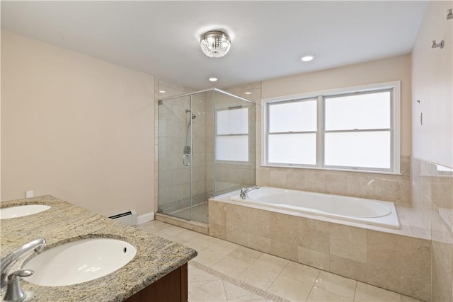 bathroom with tile patterned floors, plus walk in shower, vanity, and a baseboard heating unit