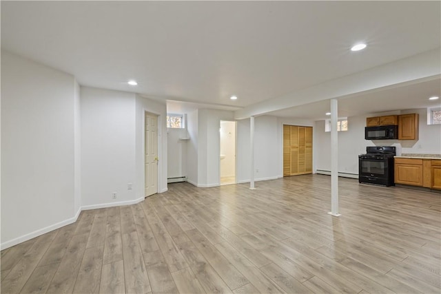 unfurnished living room with light hardwood / wood-style floors and a baseboard radiator