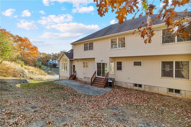 rear view of house with central AC unit