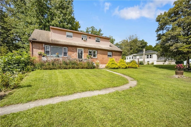 rear view of house with a lawn