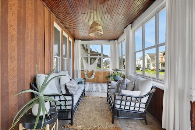 sunroom featuring wood ceiling