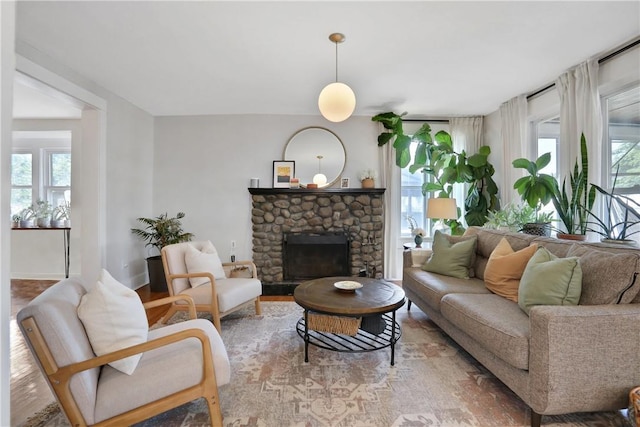 living room with light wood-type flooring and a fireplace