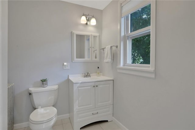 bathroom with tile patterned flooring, vanity, and toilet