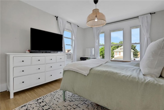 bedroom featuring light hardwood / wood-style floors and multiple windows