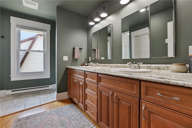 bathroom featuring hardwood / wood-style floors, vanity, and baseboard heating