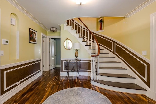 staircase with hardwood / wood-style floors and crown molding