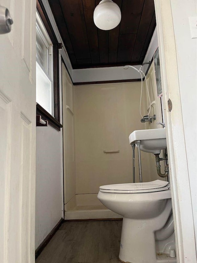 bathroom with hardwood / wood-style floors, wood ceiling, and toilet