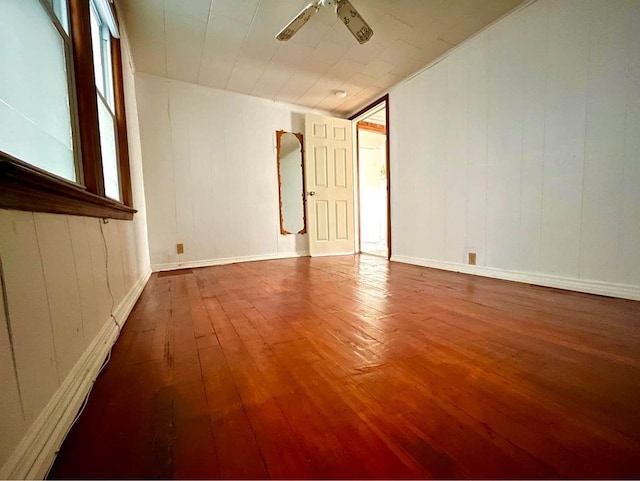 empty room with ceiling fan and wood-type flooring