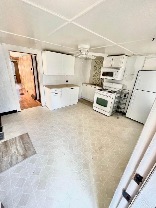 kitchen featuring backsplash, white appliances, ceiling fan, white cabinets, and light hardwood / wood-style floors