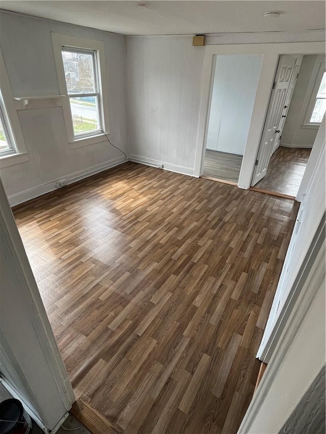 unfurnished room with dark hardwood / wood-style floors and a wealth of natural light