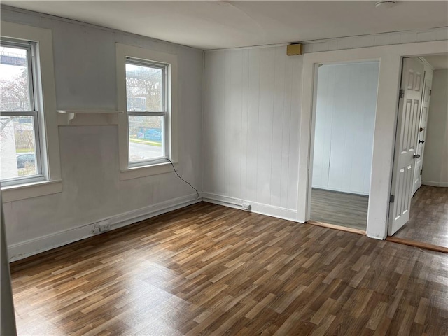 unfurnished room with dark hardwood / wood-style floors