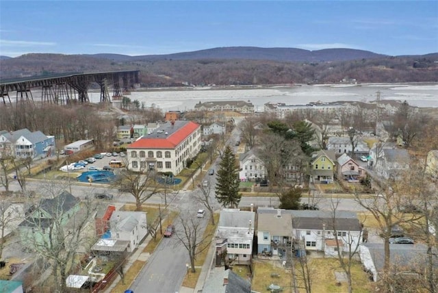 birds eye view of property featuring a water and mountain view