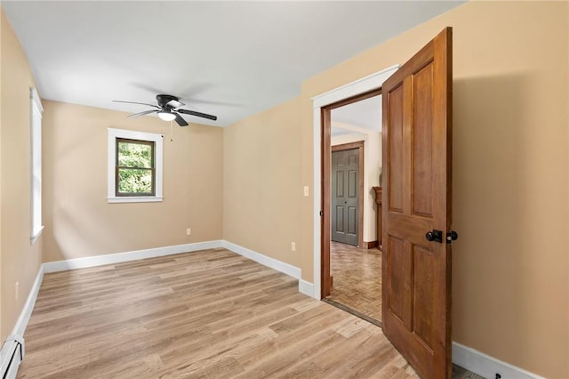 unfurnished room with light wood-type flooring, a baseboard radiator, and ceiling fan