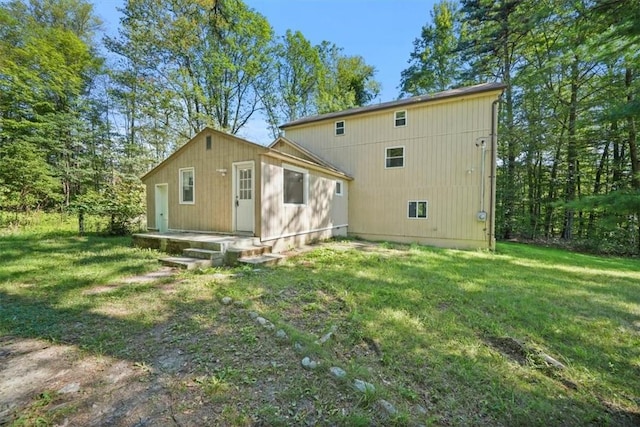 rear view of property with a lawn