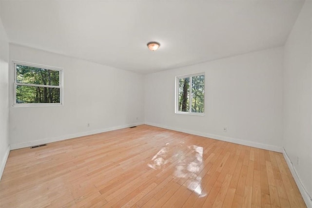 empty room with light hardwood / wood-style floors