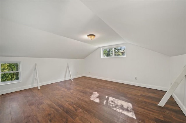 bonus room featuring dark hardwood / wood-style floors and vaulted ceiling