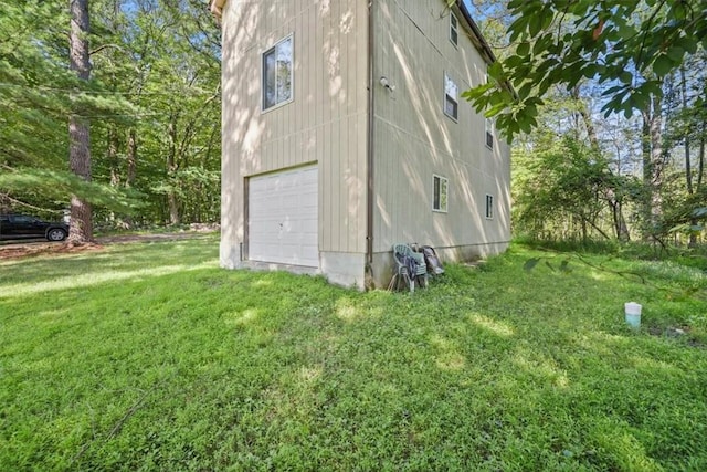 view of side of property with a garage and a yard