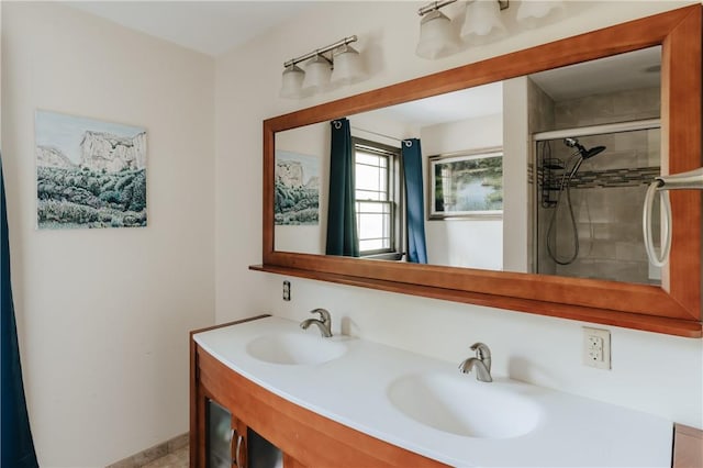 bathroom with vanity and tiled shower