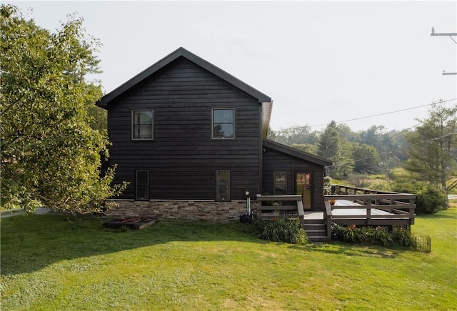 view of home's exterior with a lawn and a deck