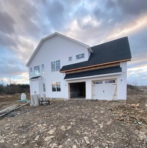 back of house with a garage