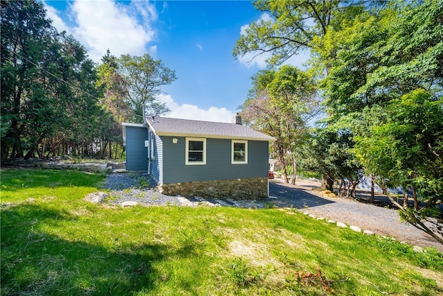 view of home's exterior with a yard