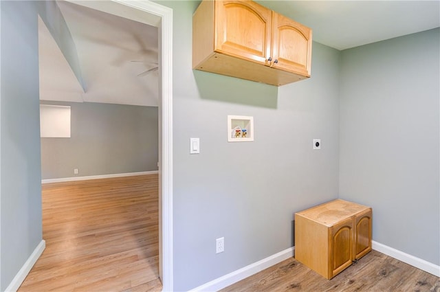 clothes washing area with cabinets, washer hookup, light hardwood / wood-style flooring, and electric dryer hookup