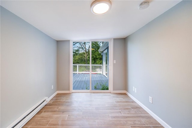 spare room featuring light hardwood / wood-style flooring and a baseboard heating unit