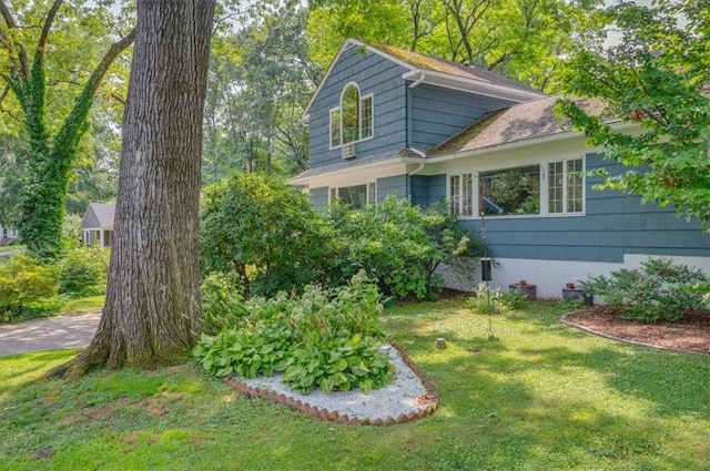 view of side of home featuring a yard