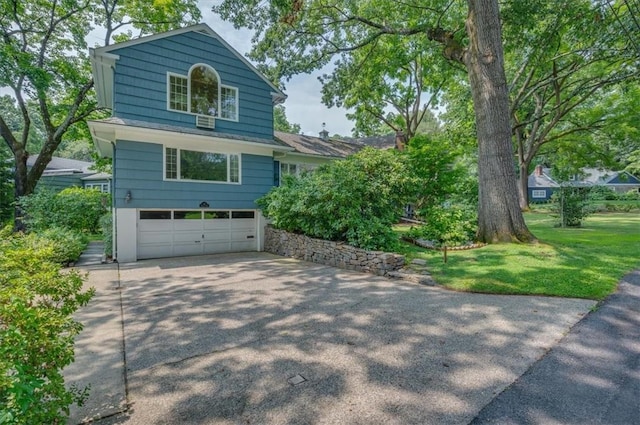 view of side of home with a lawn and a garage