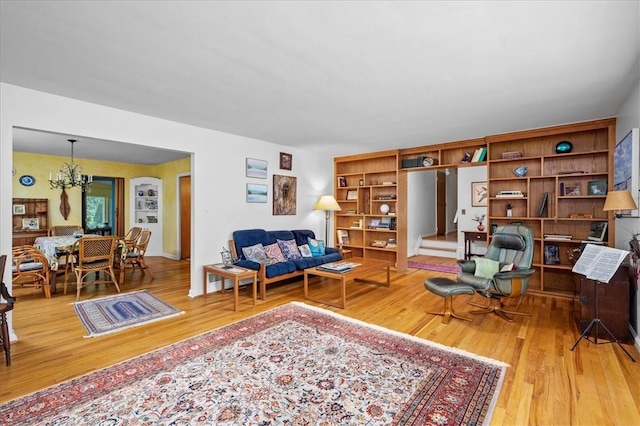 living room with a notable chandelier and hardwood / wood-style flooring